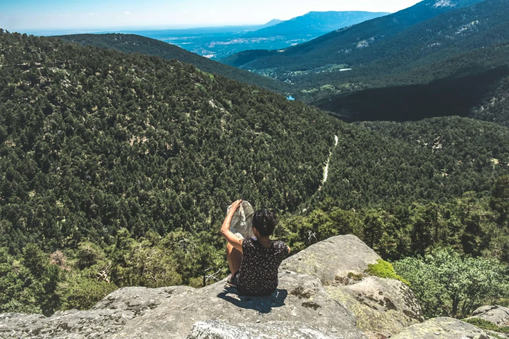 Lost hiker calmly reviewing map and planning next steps in remote backcountry