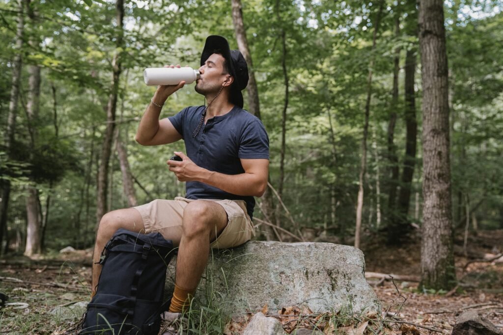 Hiker drinking water in shaded area