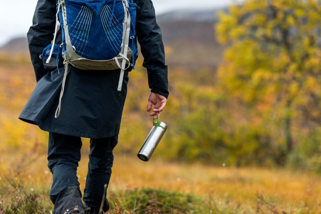 Hiking hydration: A hiker carrying small bottle of water.