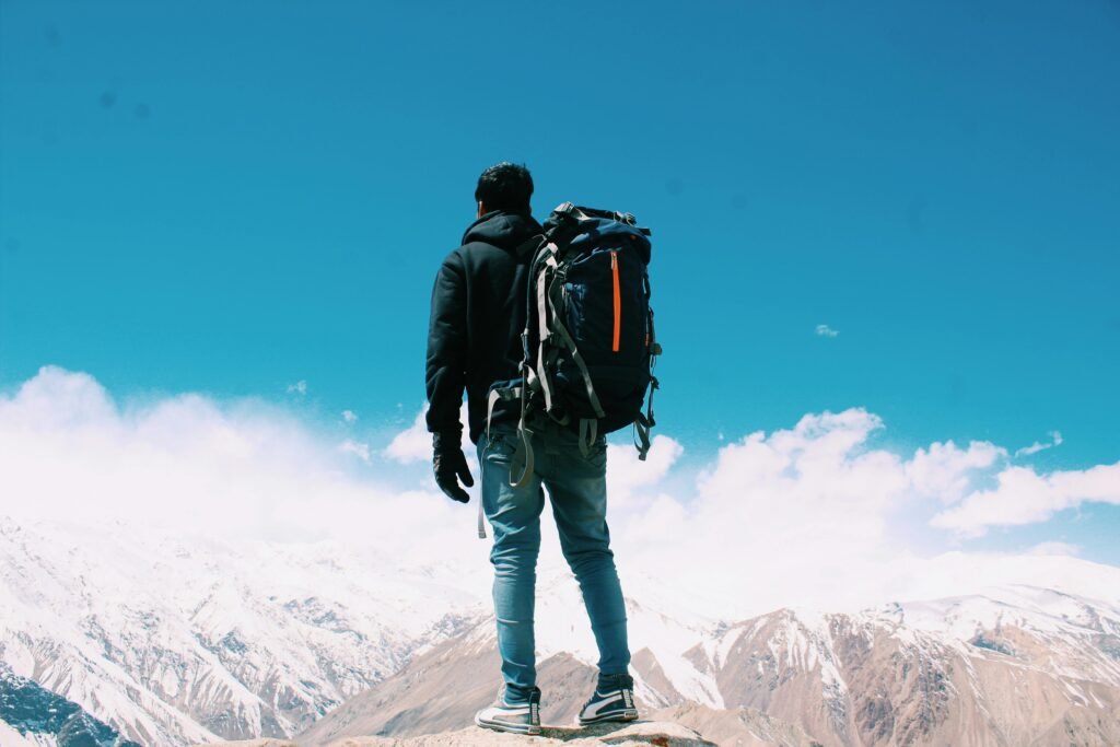 A hiker with a hiking backpack in the mountains