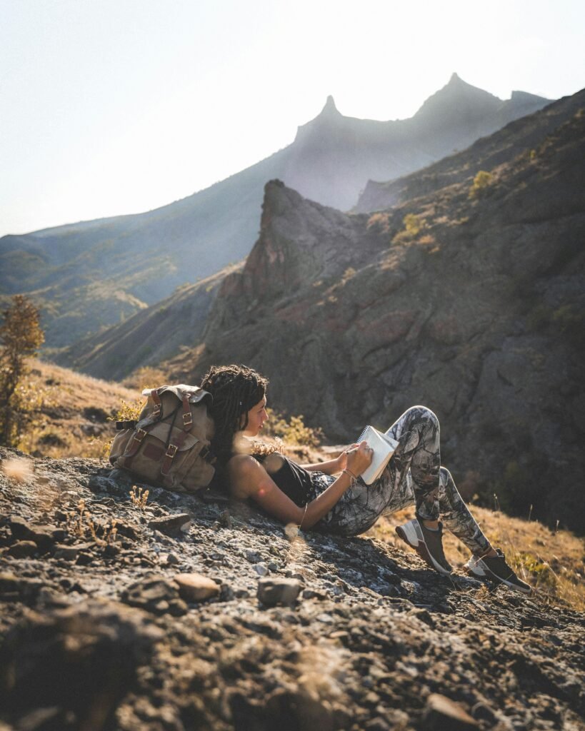 girl taking notes for a hiking blog on a mountain