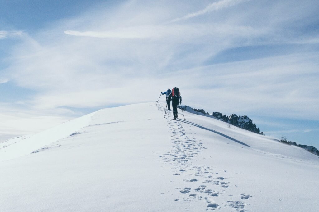 Hikers walking in snow in mountains